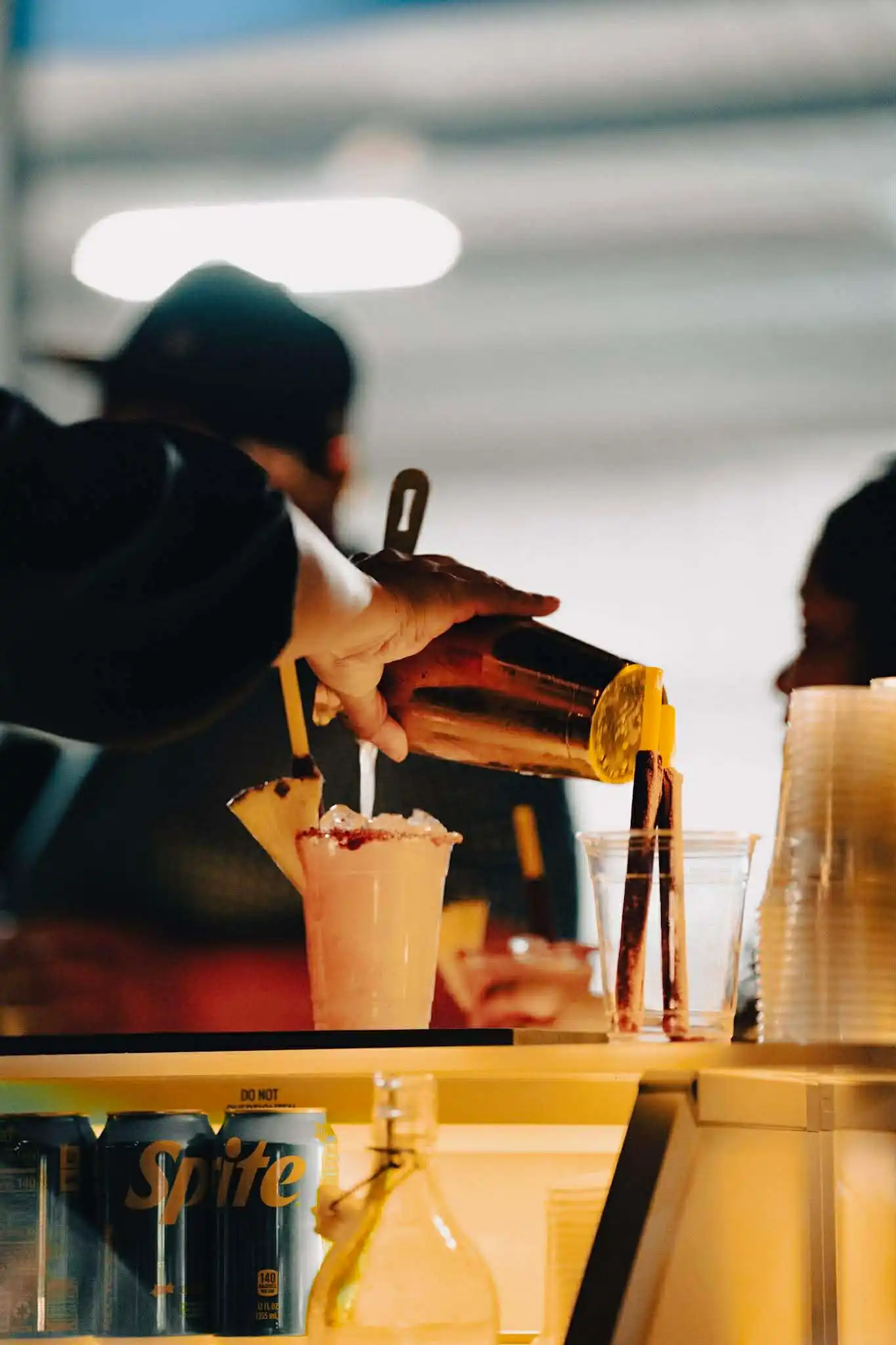 Bartender pouring signature cocktail